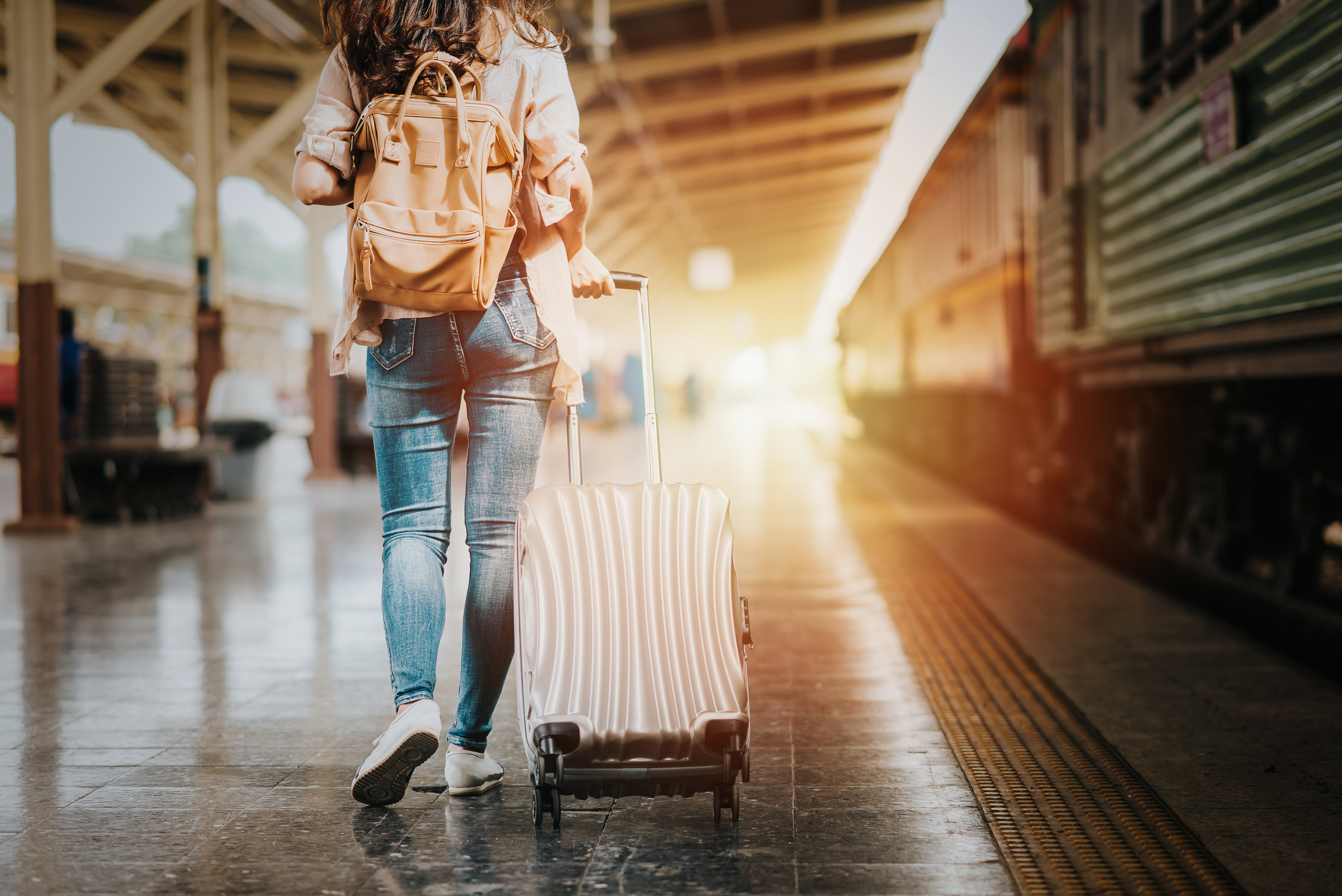 Woman Traveler Holding Luggage on Train Platform